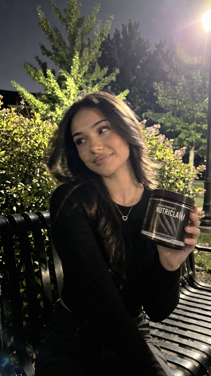 Woman at the park holding NutriClaw Creatine Monohydrate