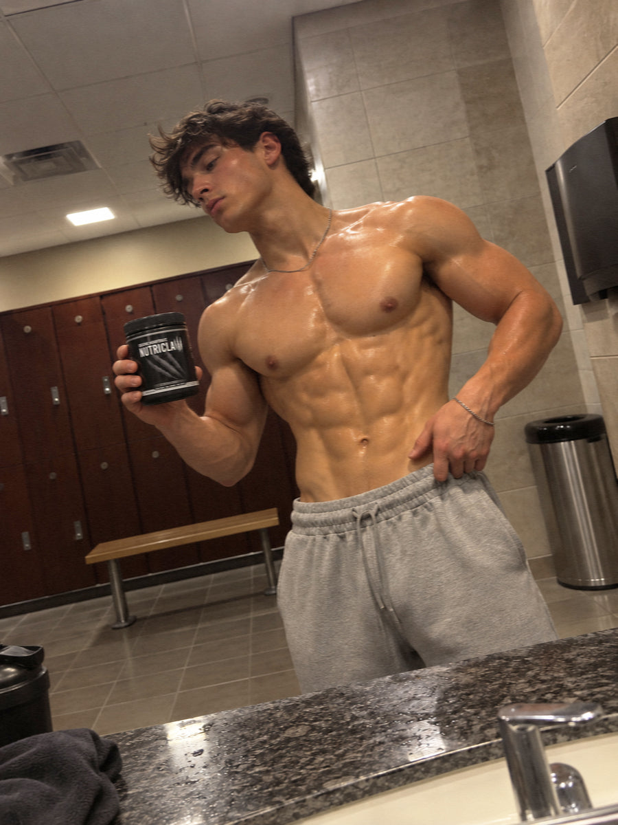 Athletic man holding a NutriClaw supplement container